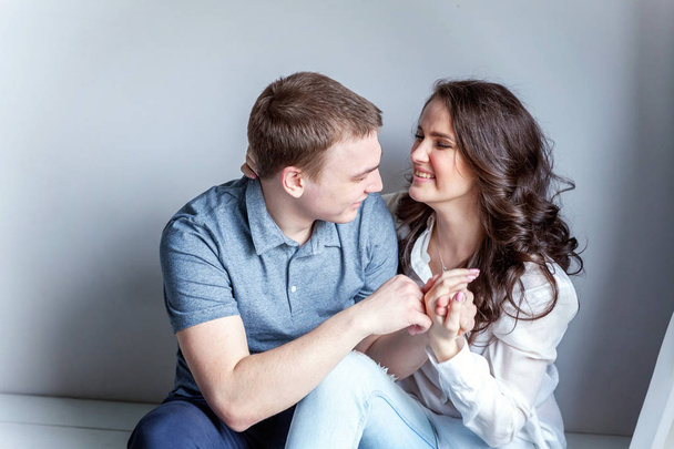 Romantic sexy couple in love having nice time together. Young woman hugging boyfriend, white background - Zdjęcie, obraz