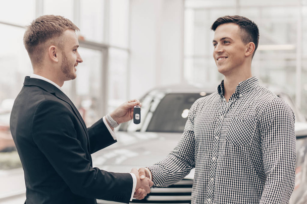 Car salesman working with a customer at the dealership - Photo, Image