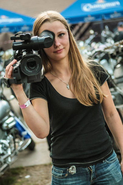 Beautiful girl videographer at the biker festival.Ukraine,Cherka - Foto, Imagen