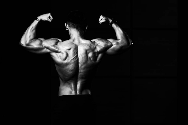Muscular Men Is Hitting Rear Double Bicep Pose - 写真・画像