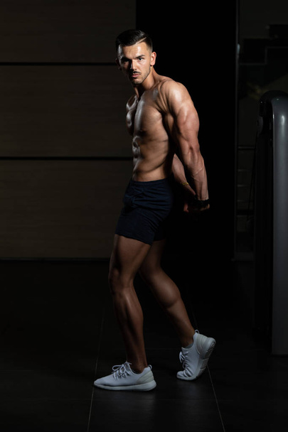 Muscular Man Flexing Muscles Side Triceps Pose - 写真・画像