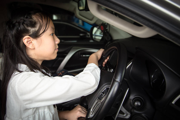 Asian little girl driving a car  - Fotó, kép