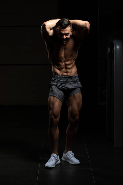 Serious Bodybuilder Standing In The Gym - 写真・画像