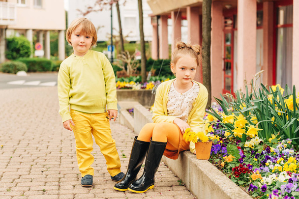 Outdoor portrait of adorable fashion kids, wearing yellow clothes - Photo, Image