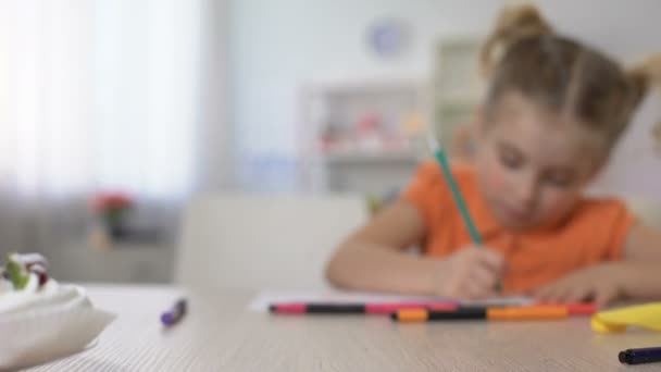 Studious little girl writing with pencil at home table, childhood education - Footage, Video
