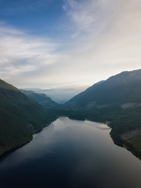 Aerial view of a scenic lake in the Canadian Mountain Landscape during a vibrant summer sunrise. Taken at Jones Lake near Chilliwack and Hope, East of Vancouver, BC, Canada. - Zdjęcie, obraz