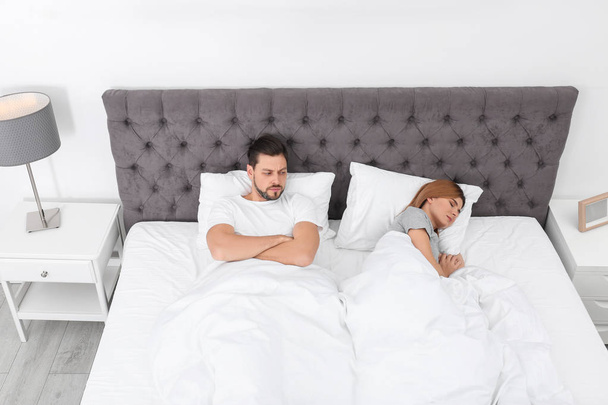 Couple with relationship problems in bed at home - Foto, afbeelding