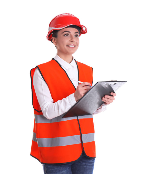Female industrial engineer in uniform with clipboard on white background. Safety equipment - Zdjęcie, obraz