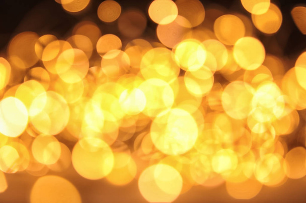 Gold glitter with bokeh effect on dark background - Φωτογραφία, εικόνα