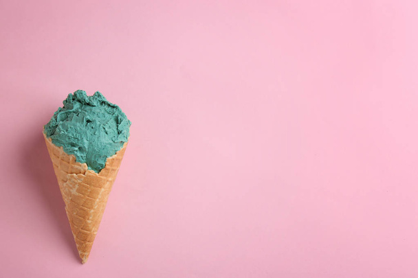 Delicious spirulina ice cream cone on color background, top view. Space for text - Photo, Image