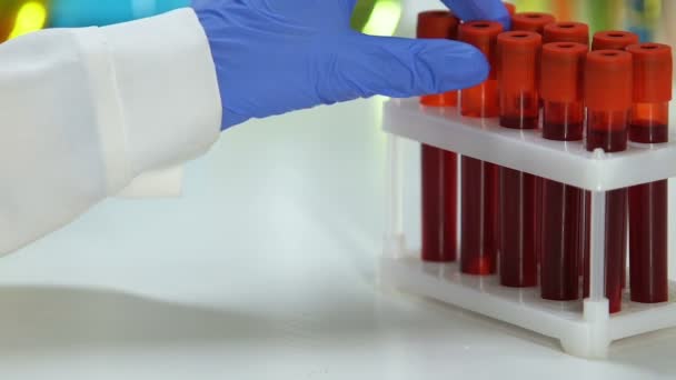 Laboratory scientist taking test tube with blood sample, biochemical test - Footage, Video