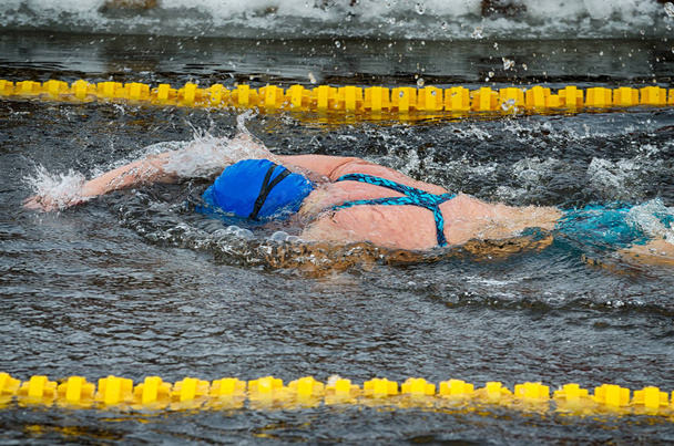 Lovers of winter swimming.Swimmer swims in the pool. - Photo, Image