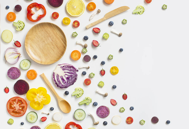 Colourful assorted raw vegan food sliced on white background. - Photo, Image