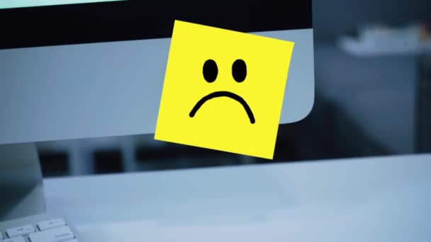 Sad smile. Sad face painted on a sticker on the monitor. Message. Motivation. Reminder. Handwritten text written with a marker. Color sticker. A message for an employee, a colleague - Footage, Video