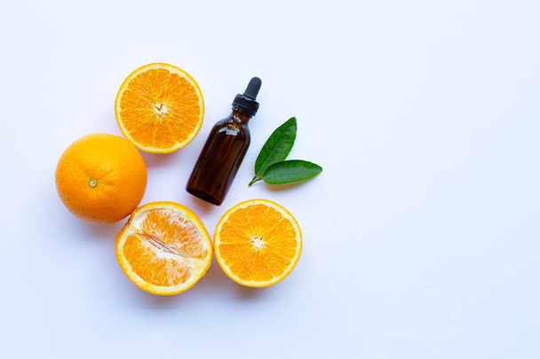 Orange essential oil on white background.  - Foto, imagen
