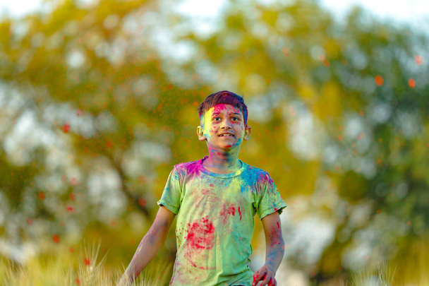 Ινδική παιδί που παίζει με το χρώμα στο Φεστιβάλ holi - Φωτογραφία, εικόνα
