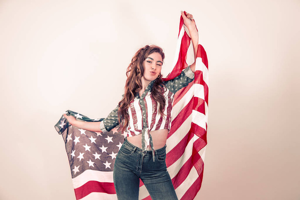 Patriotyczne dziewczyna z flagą Ameryki na kolorowym tle - Zdjęcie, obraz