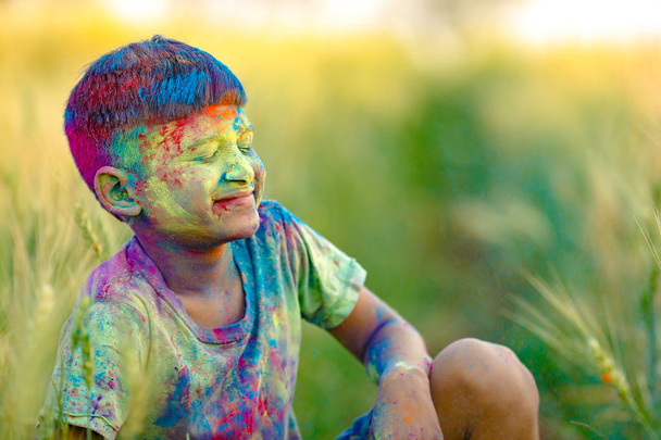 Indian child playing with the color in holi festival - Photo, Image