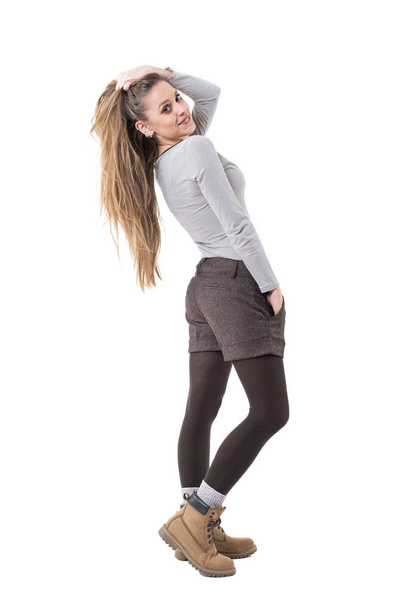 Side view of cute beautiful long hair hipster blonde girl bending backward posing and modelling. Full body isolated on white background.  - Fotó, kép
