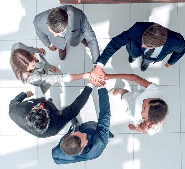 top view. a group of business people with their hands folded together - Фото, изображение