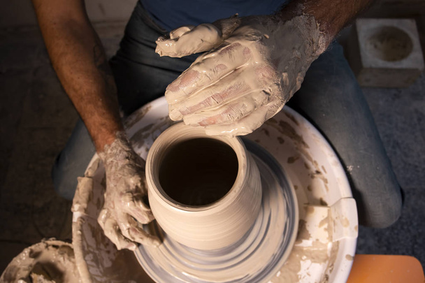 Professional potter making bowl in pottery workshop - Photo, Image