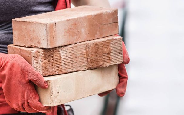 Woman working with bricks - Фото, зображення