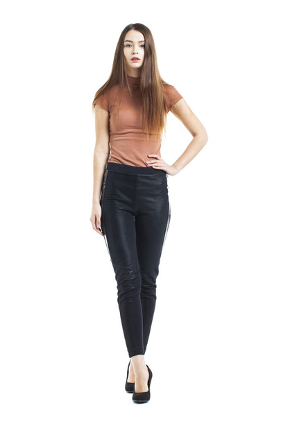 Full body, Young beautiful brunette woman in black pants - Photo, Image