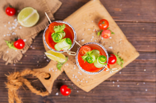 Two glasses of fresh organic tomato juice decorated with raw tom - Photo, image