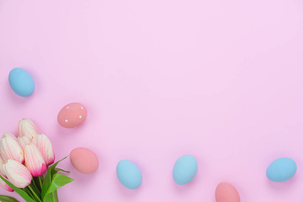Table top view shot of decorations Happy Easter holiday background concept.Flat lay simple minimal bunny eggs & with tulip on modern rustic pink paper.Copy space for creative design mock up & template - 写真・画像