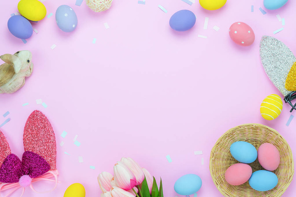 Table top view shot of decorations Happy Easter holiday background concept.Flat lay arrangement colorful bunny eggs &  with decor for party festival season on modern rustic pink paper.Space for design - Foto, Imagem