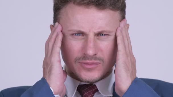 Face of stressed bearded businessman having headache - Felvétel, videó