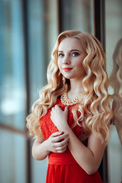 portrait of stylish beautiful girl wearing short red dress posing or walking at the street - Foto, imagen