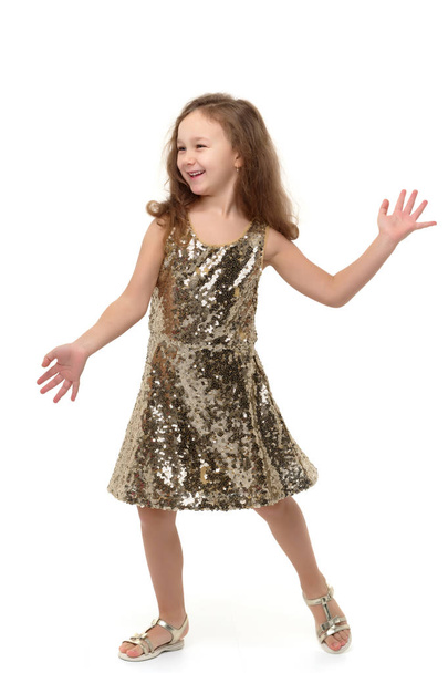 A cheerful little girl is dancing. - Foto, Bild