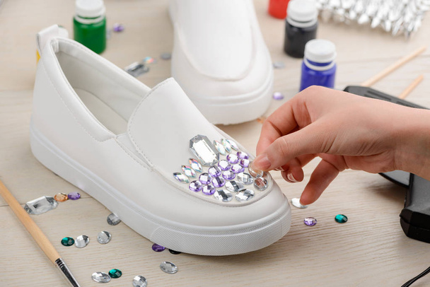 Girl adding rhinestones to shoes - Fotografie, Obrázek
