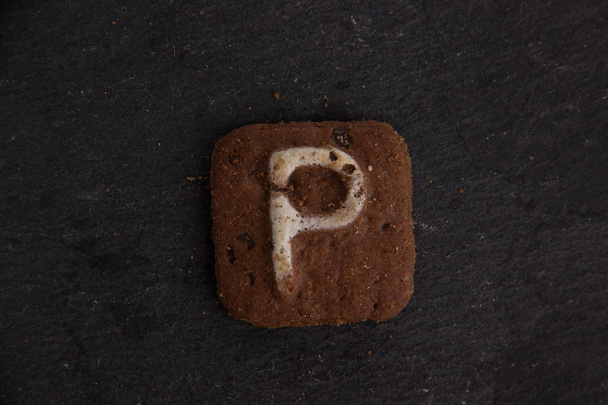 letras de galletas sobre fondo de piedra negra
 - Foto, imagen