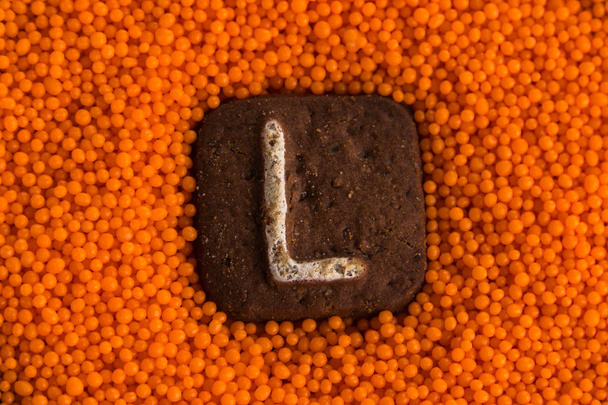 cookies with letters on the background of orange sweet balls - Photo, Image