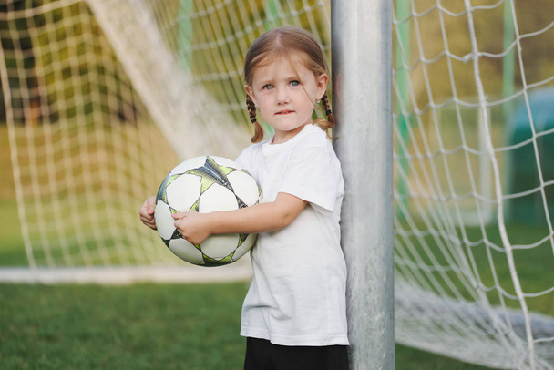 little happy girl on football field - Foto, Imagem