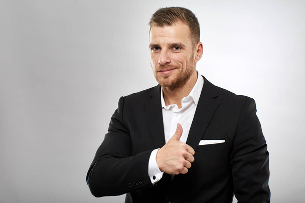 Caucasian businessman showing thumbs up sign - Photo, image