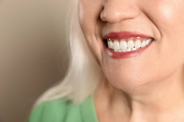 Smiling woman with perfect teeth on color background, closeup. Space for text - Foto, immagini