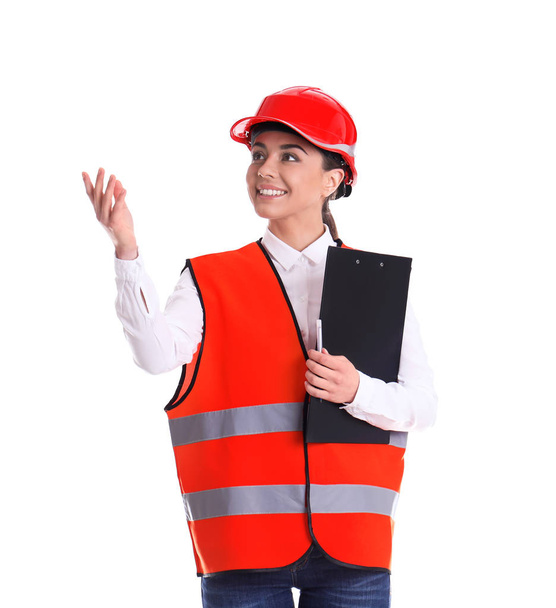 Female industrial engineer in uniform with clipboard on white background. Safety equipment - Foto, Imagen