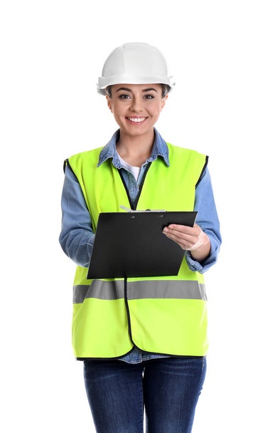 Female industrial engineer in uniform with clipboard on white background. Safety equipment - Foto, afbeelding