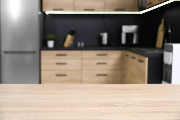 Countertop and blurred view of cozy modern kitchen interior on background - Foto, Bild