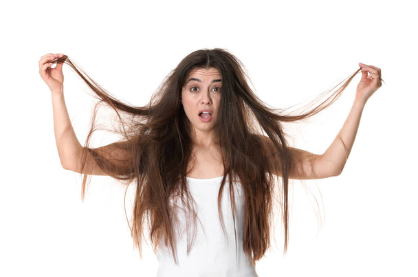 Emotional woman with tangled hair on white background - Photo, image
