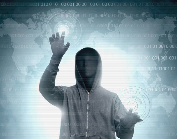 Hacker in black hoodie touching virtual screen with binary code - Photo, image