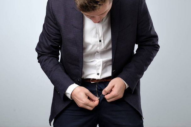 Man in suit zip his pants up. Problem with broken fly. - Foto, afbeelding
