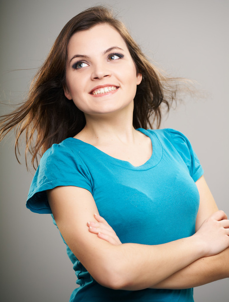 Attractive young woman in a blue shirt. Woman standing with fold - Fotoğraf, Görsel
