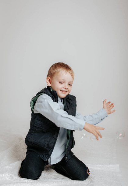 Little boy playing with soap bubbles - Photo, Image