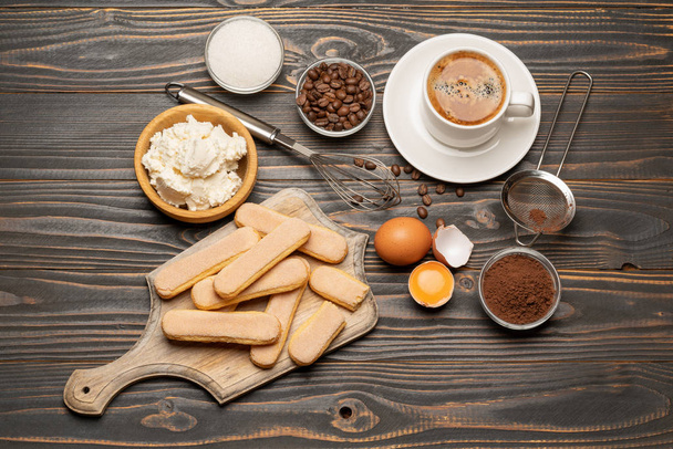 Ingredients for cooking tiramisu - Savoiardi biscuit cookies, mascarpone, cream, sugar, cocoa, coffee and egg - Photo, image