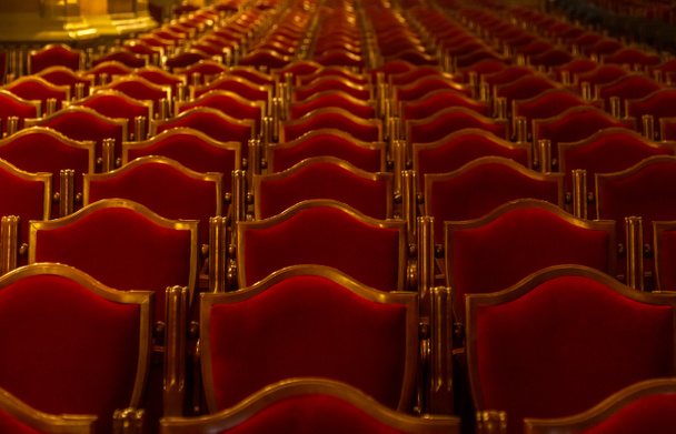Interior theater art. Audience with empty soft armchairs of Opera and Ballet Theater is waiting for audience. Empty interior of concert theater before performance and without spectators. Soft focus - Photo, Image