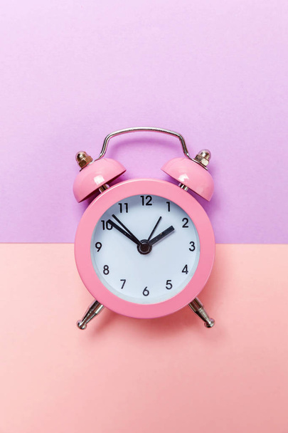 Vintage alarm clock Isolated on purple pink pastel background - Foto, Imagen